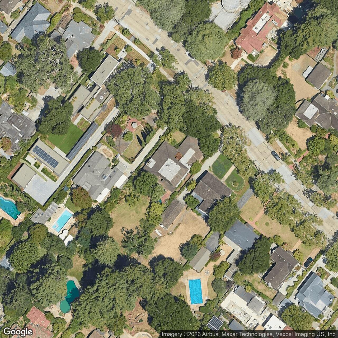 Satellite photograph of 1952 Waverley St, with the recorded lot line and the roof outline drawn over it